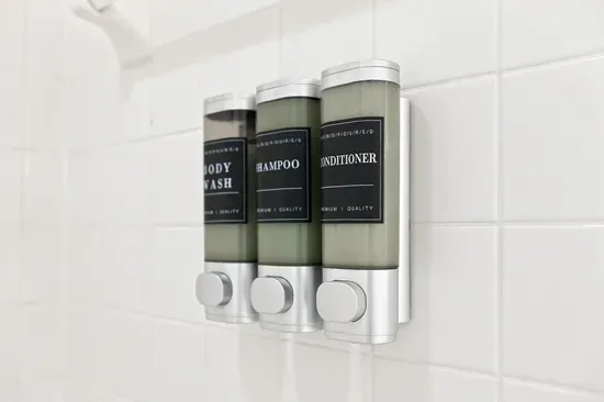 Hotel-style shower with mounted shampoo, conditioner, and body wash