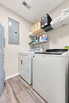 Convenient in-unit laundry room with full-size washer, dryer, and storage