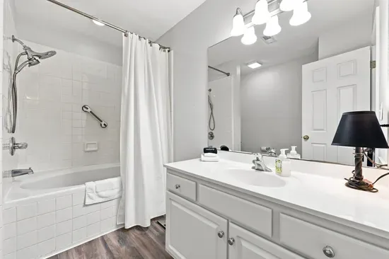 Bright full bathroom with spacious vanity and tub-shower combo