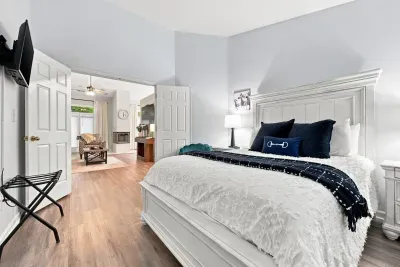Spacious, elegant bedroom with plush king bed and adjoining sitting area