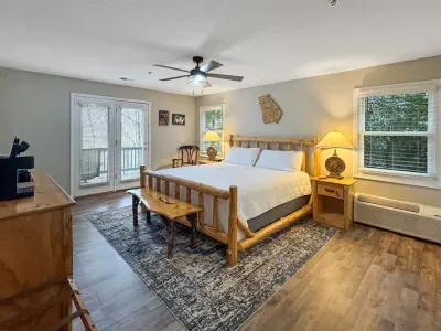 Natural light fills the room, with easy access to the deck for fresh air and peaceful mornings surrounded by trees.