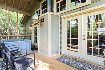 Grill up dinner or kick back and relax — your private screened porch features a hot tub, TV, comfy seating, and plenty of fresh mountain air.