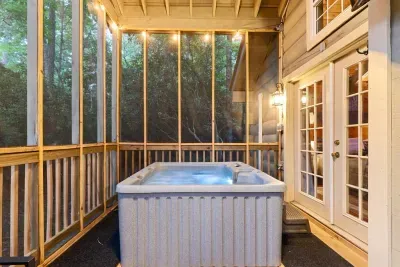 The screened porch is your forest escape. Sip your morning coffee or soak in the hot tub surrounded by trees.