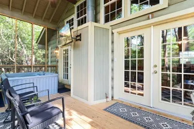 Grill up dinner or kick back and relax — your private screened porch features a hot tub, TV, comfy seating, and plenty of fresh mountain air.