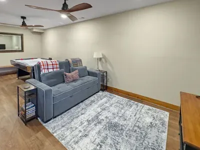 Kick back in the cozy 'chill zone.' 🍿 This comfortable seating area in the game room is the perfect spot to relax between air hockey matches or settle in for a movie night. It’s the ultimate hangout space for kids and adults alike!