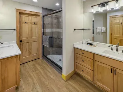 Luxury and privacy combined. ✨ This spacious en-suite features a large walk-in glass shower with custom tile work and a sleek vanity. With four full bathrooms, everyone in your group has the space they need to refresh in style.