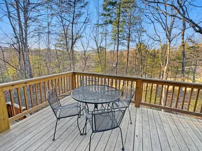 Enjoy your morning coffee with a view! ☕ This private deck features comfortable mesh seating for four, perfect for taking in the serene forest and golf course vistas that surround our peaceful mountain retreat.