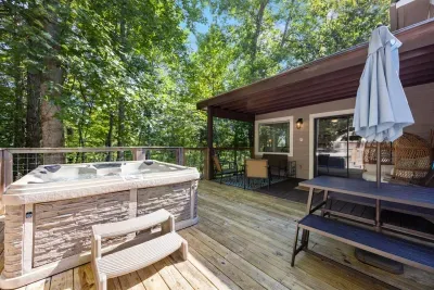Private hot tub on the deck for relaxing evenings under the trees.