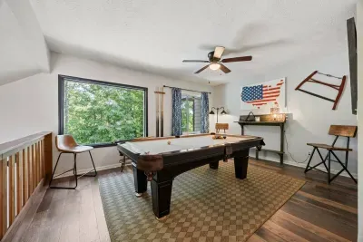Spacious game room with a full-size pool table for family fun and friendly competition.