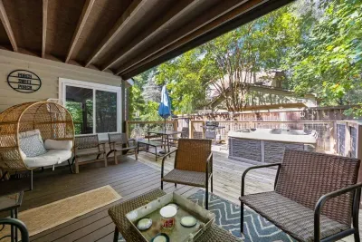 Relax on the covered deck surrounded by trees—your morning coffee spot awaits.