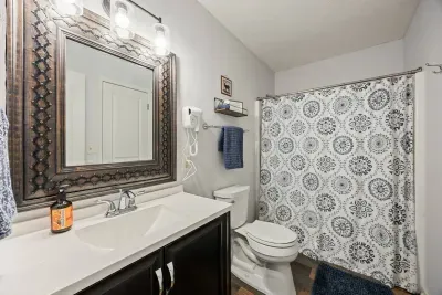 Bright and clean bathroom with a full shower and everything you need for your stay.