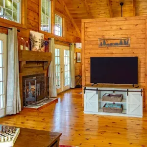 Inviting living room with vaulted ceilings, cozy fireplace, and Smart TV