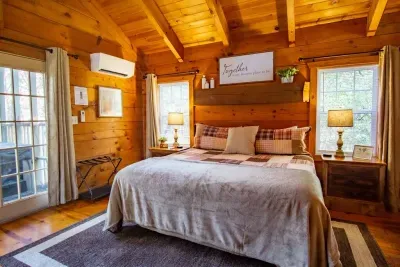 Alternate view of the king bedroom with cozy lighting and cabin charm.