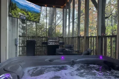 Private hot tub with forest views, outdoor seating, and grill for relaxing nights.
