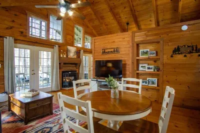 Open dining and kitchen space with vaulted ceilings and natural light