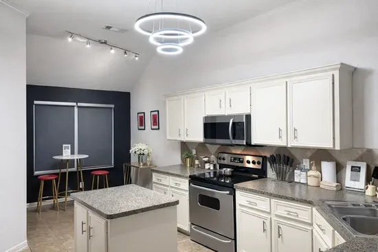 Fully equipped kitchen and bar seating for intimate meals.