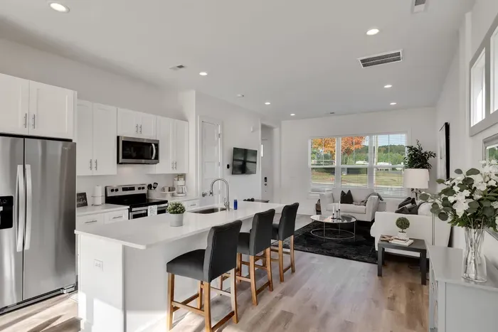 Stylish open-concept kitchen and living space with a large island, stainless appliances, and seamless space for cooking and socializing.