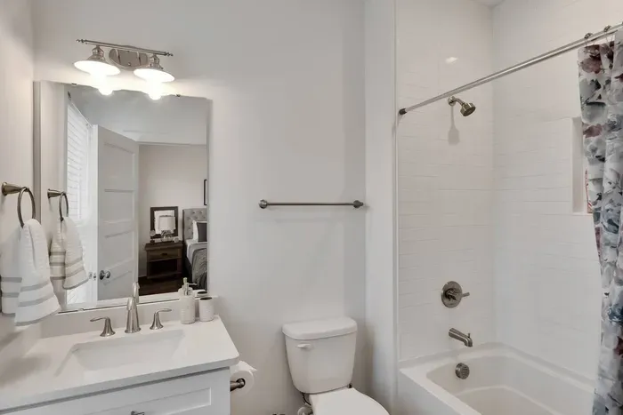 Enjoy a clean, bright bathroom with a full shower and tub combo — complete with modern fixtures and fresh towels