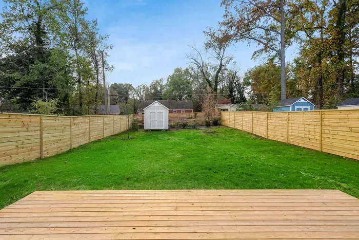 Step out onto the spacious deck overlooking a large, fenced backyard