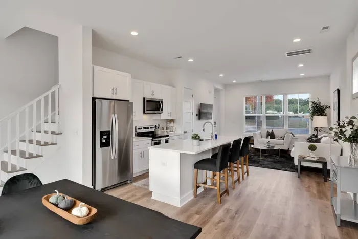 Seamless transition between the dining area, kitchen, and the living room creating a welcoming vibe!