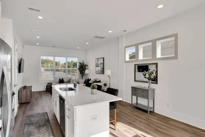 Sleek open layout blending kitchen and living space, filled with natural light and modern charm.