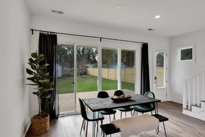 Sunlit dining nook with backyard views and seamless walk-out to the deck.