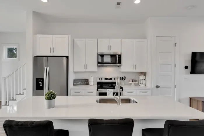 A large quartz island and clean, modern design for effortless cooking and hosting.