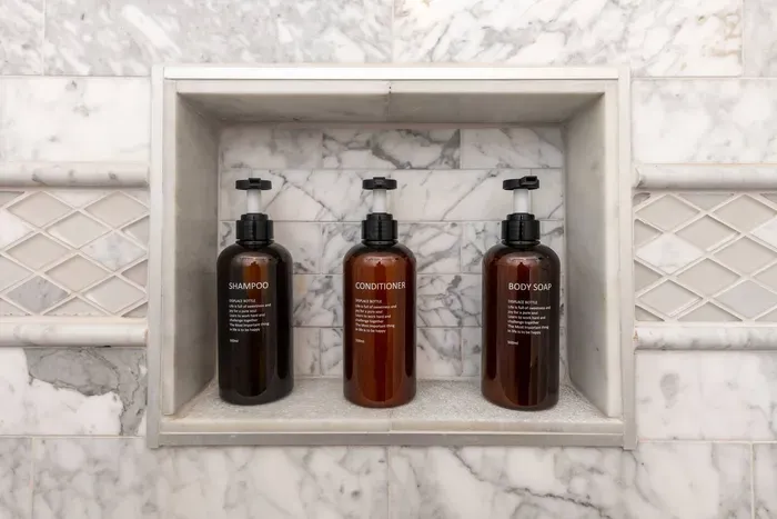 Newly renovated master bathroom with double vanity and stocked with body wash, shampoo, conditioner, hair dryer and towels.