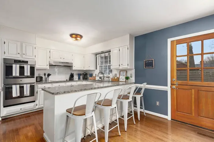 Newly renovated kitchen with barstool seating for four.