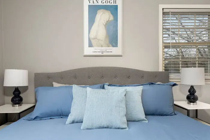 Beautiful master bedroom with king bed, two closets and two nightstands with storage.