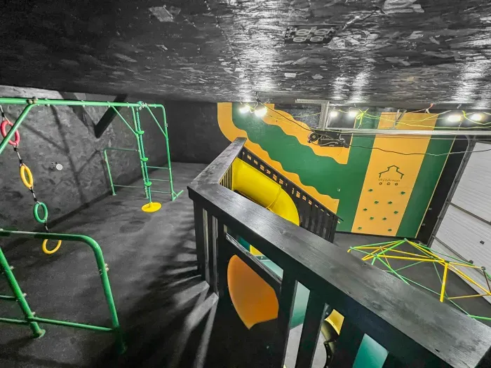 Fully equipped indoor commercial park and playground with 2 tube slides, a hexagon climbing dome, rock climbing wall, 3 tire swings and a 15ft monkey bar installation. Heated and cooled year-round, located in the party shed next to the plunge pool.