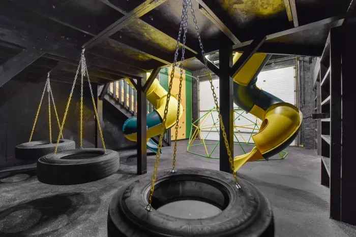 Fully equipped indoor commercial park and playground with 2 tube slides, a hexagon climbing dome, rock climbing wall, 3 tire swings and a 15ft monkey bar installation. Heated and cooled year-round, located in the party shed next to the plunge pool.