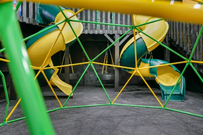 Fully equipped indoor commercial park and playground with 2 tube slides, a hexagon climbing dome, rock climbing wall, 3 tire swings and a 15ft monkey bar installation. Heated and cooled year-round, located in the party shed next to the plunge pool.