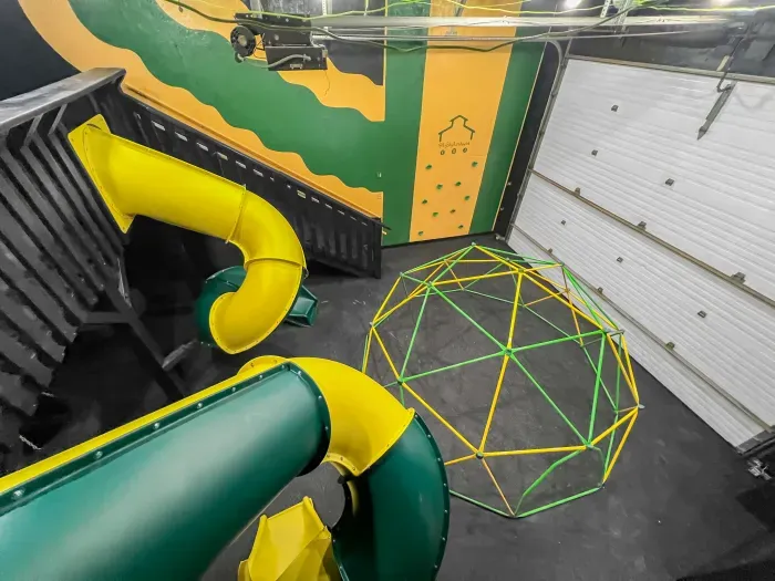 Fully equipped indoor commercial park and playground with 2 tube slides, a hexagon climbing dome, rock climbing wall, 3 tire swings and a 15ft monkey bar installation. Heated and cooled year-round, located in the party shed next to the plunge pool.