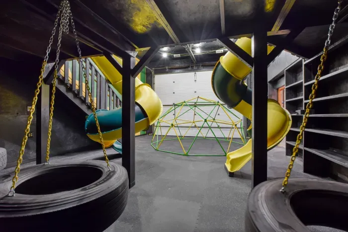 Fully equipped indoor commercial park and playground with 2 tube slides, a hexagon climbing dome, rock climbing wall, 3 tire swings and a 15ft monkey bar installation. Heated and cooled year-round, located in the party shed next to the plunge pool.