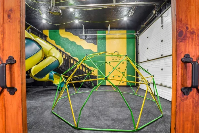 Fully equipped indoor commercial park and playground with 2 tube slides, a hexagon climbing dome, rock climbing wall, 3 tire swings and a 15ft monkey bar installation. Heated and cooled year-round, located in the party shed next to the plunge pool.