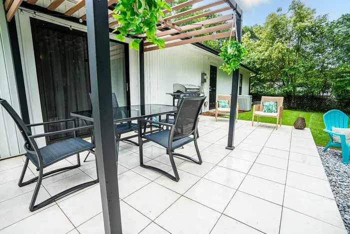 Sleek outdoor dining table and chair set with seating for 4 people. 