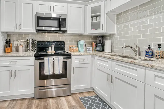 Modern kitchen fully stocked with all the equipment needed to cook meals.