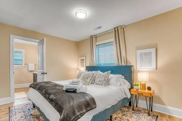 Relax in the uniquely curated design of the king bedroom with plenty of pillows, two nightstands, 40" Roku TV and ensuite master bathroom. 