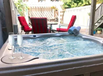 Hot tub on the back patio next to the pool and entertainment space