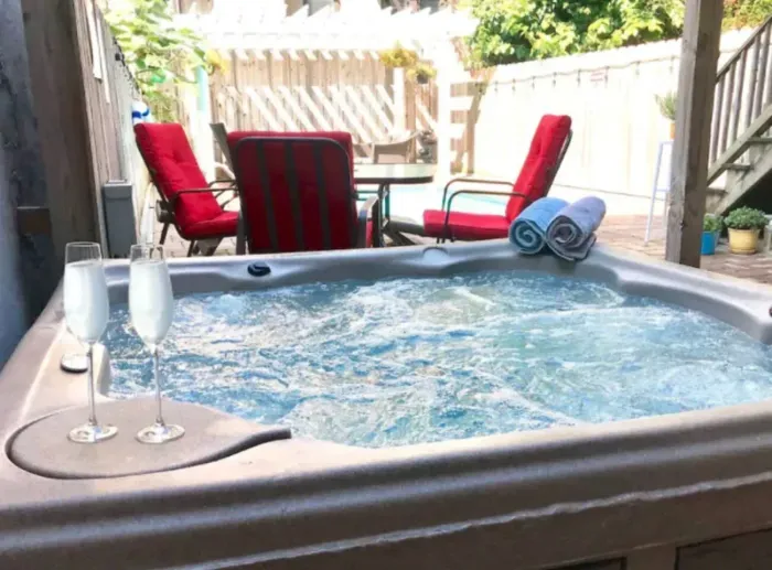 Hot tub on the back patio next to the pool and entertainment space 