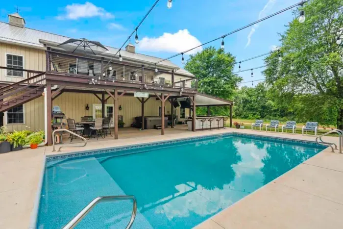 Outdoor saltwater pool with an automatic cover. Pool side lounge and wet bar with flatscreens and a hot tub.