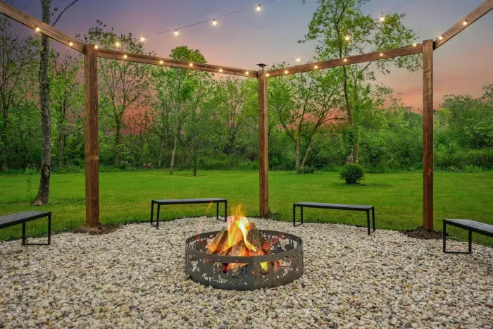 Fire Pit under a Hexagon Pergola with Solar Powered dusk to dawn string lights!