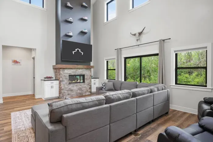 Large living room with Nike-Outlet esque themed TV mantle wall