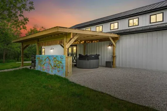 TIKI BAR! On the back covered patio w/ a hot tub + outdoor lounge + Weber Grill!