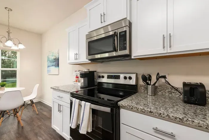 Modern kitchen with granite countertops, stainless steel appliances, coffee station, and everything you need for a home-cooked meal.