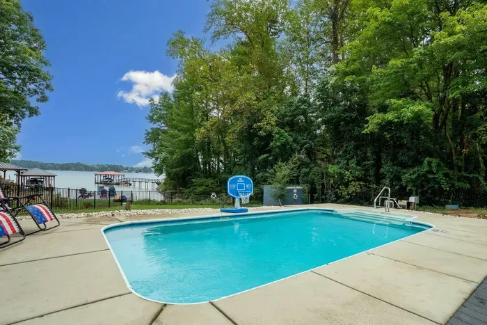 Our beautiful heated pool overlooking the backyard and lakefront view. 