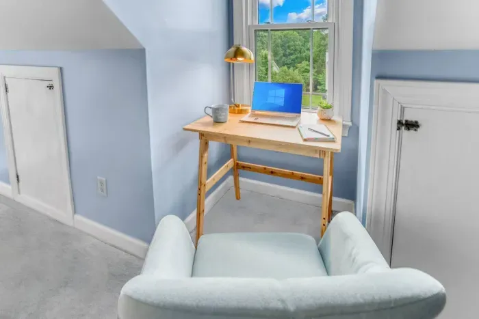 Workspace with a wooden desk and comfortable seat. 