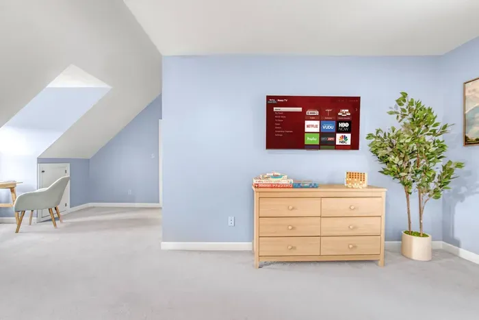 43in Smart TV on top of the dresser. Look close at the assortment of board games! 

Monopoly, Candyland, Connect 4, Cards and more!