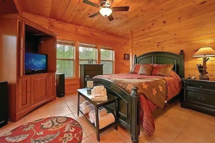 Master Suite #1 on 1st floor. Queen bed, Dish TV, full bathroom, + deck access.
